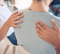 Hands, mental health and support in group therapy for woman suffering depression, stress and trauma closeup. Hand, people and aa meeting by community in trust, help and empathy for girl with anxiety