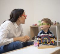 Three years old boy having a play therapy session with the psychotherapist.